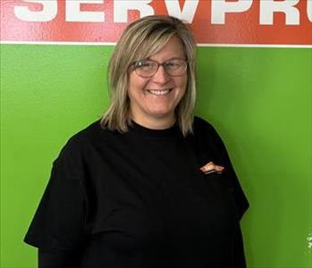 Angie in front of the SERVPRO wall 