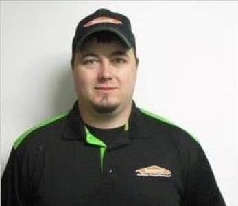 Male with Servpro hat standing infront of wall